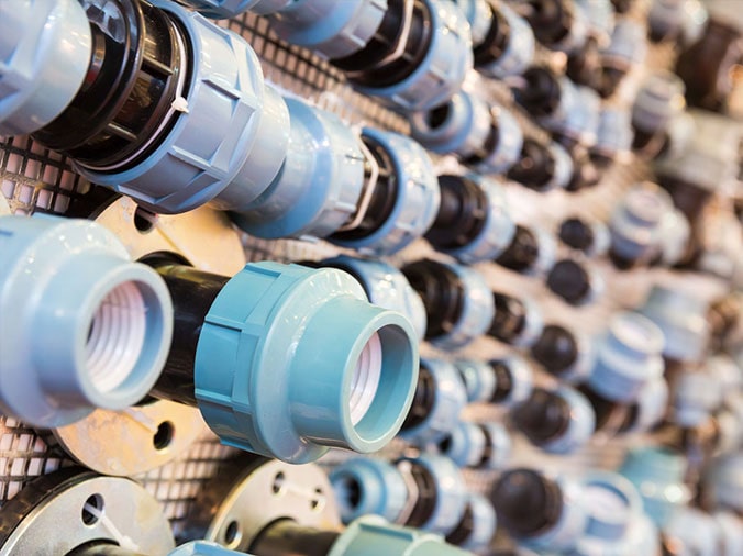 PVC unions dusplayed on the wall of a plumbing supply store